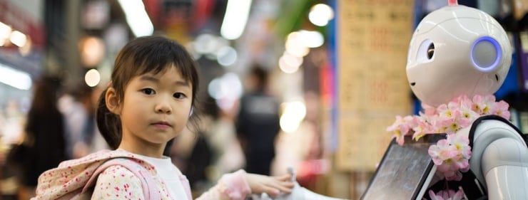 A child actor interacts with a robotic display